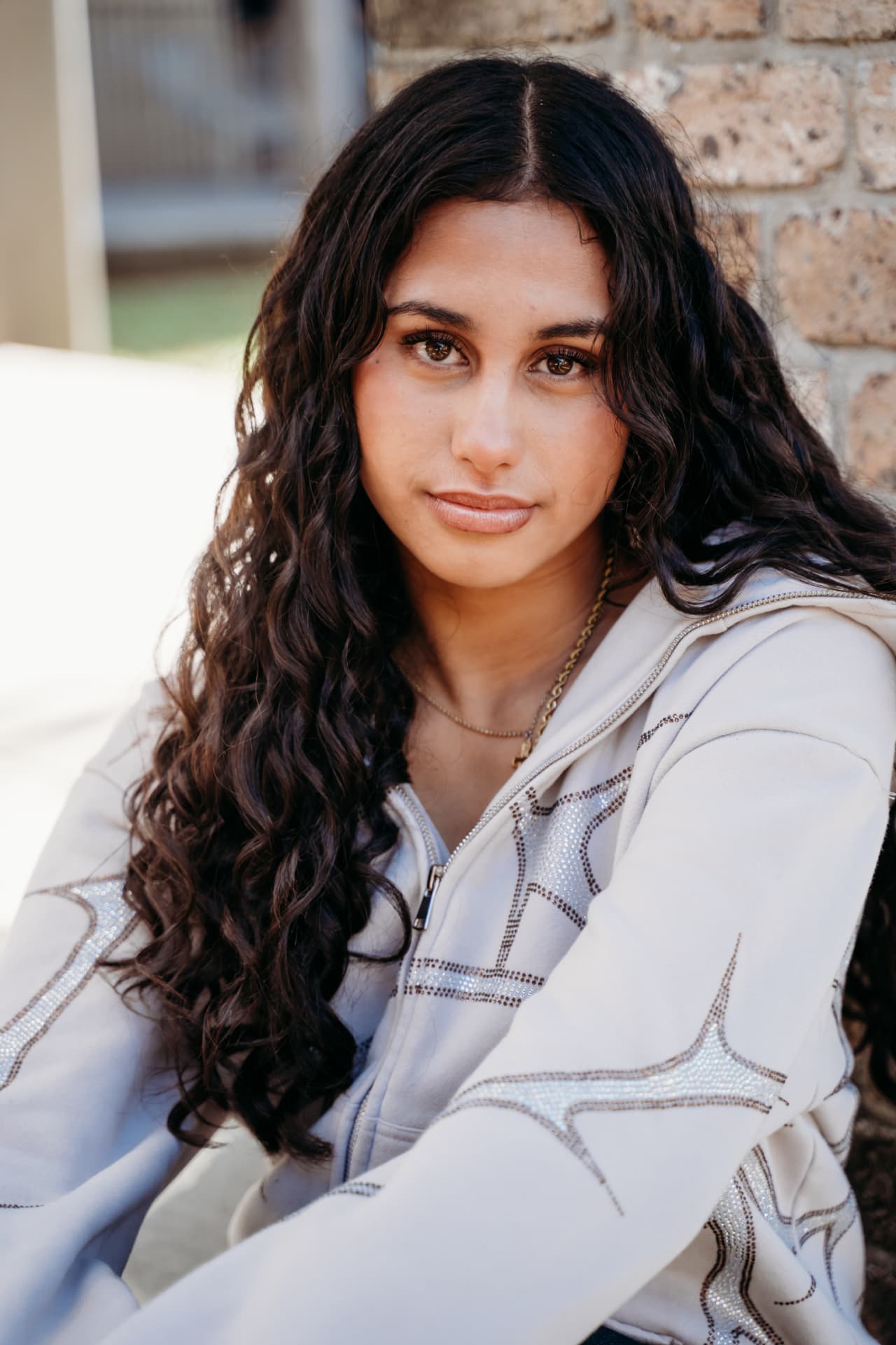 Micah editorial — Stone hoodie · sunlit brick