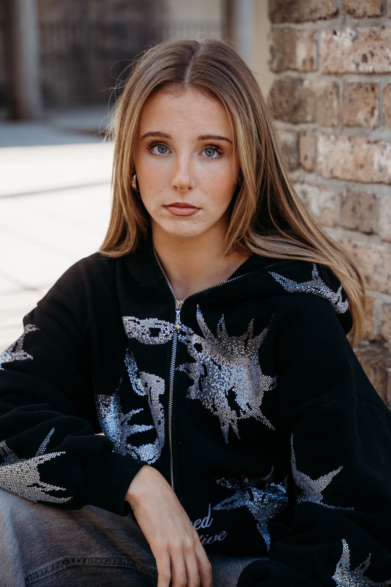 Amahlia editorial — Crystal star hoodie · brick wall